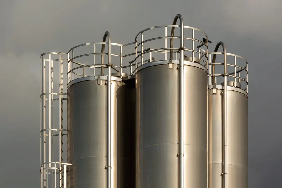 Industrial Metal Storage Tanks under Cloudy Sky